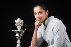 Indian Woman in front of a lamp